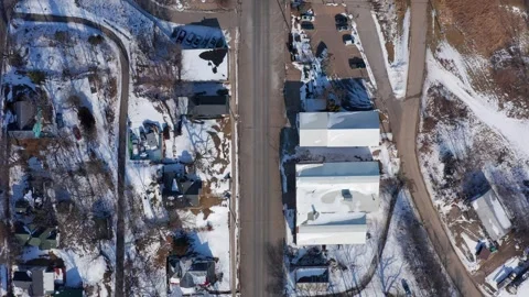 Top-Down Drone Footage of a Small Town in Winter With Snow-Covered Roads and Stock Footage 295709969