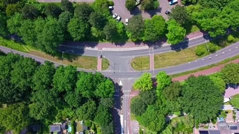 Top down drone hyperlapse of road intersection with bike paths and traffic Video stock 337351426