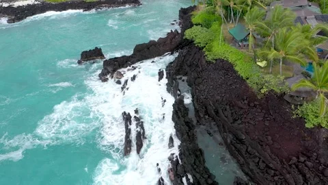 Top Down Drone Orbit of  Rugged Volcanic Beach and Turquoise Ocean next to Stock Footage 328388019