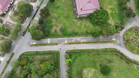 A top-down drone perspective of a circular road junction or roundabout Stock Footage 330381655