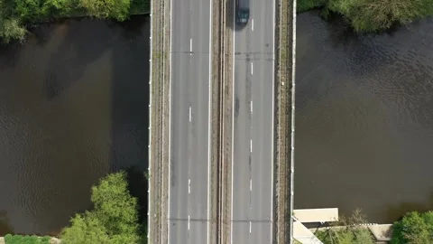 Top-down drone perspective showing cars, vans, trucks, and a motorcycle Stock Footage 308418672