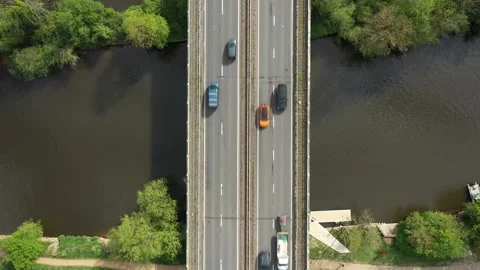 Top-down drone perspective showing cars, vans, trucks, and a motorcycle Stock Footage 308418700