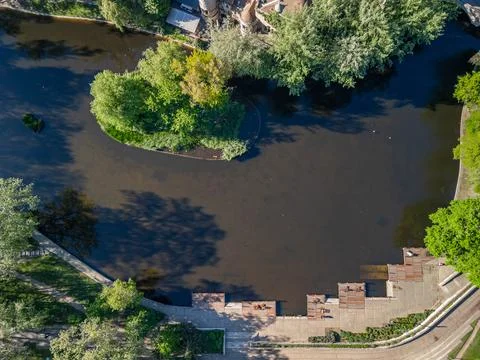 Top-Down Drone Photo of Artificial Lake with Wooden Chaise Lounges by Vajdahunya Stock Photos