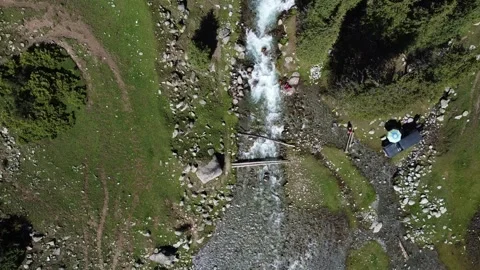 Top Down Drone Pull Away From River Camp. Kyrgyzstan, Suttuu-Bulak Lake Stock Footage 332779033