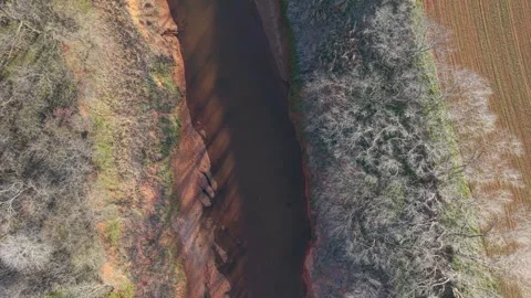 Top Down Drone of Red Dirt Creek in Rural Oklahoma at Sunset Stock Footage 331957560