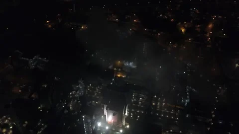 Top down drone retreat from illuminated blast furnace Stock Footage 343742754
