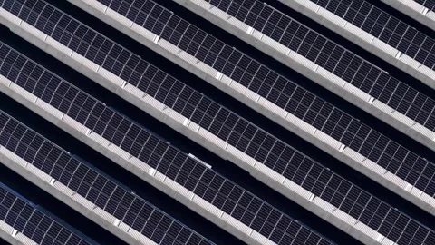 Top down drone reveal of rooftop solar panel array on industrial warehouse Stock Footage 330923240
