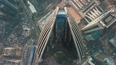 Top-Down Drone of Ribbed Skyscraper, Kuwait City—Glass Crown Above Dense Stock Footage 324895305