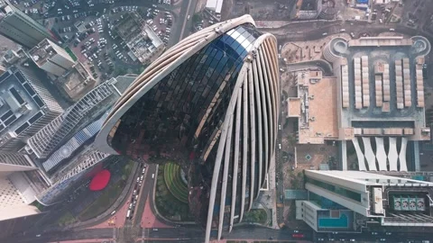 Top-Down Drone of Ribbed Skyscraper, Kuwait City—Glass Fins, Atrium, Street Grid Stock Footage 324950956