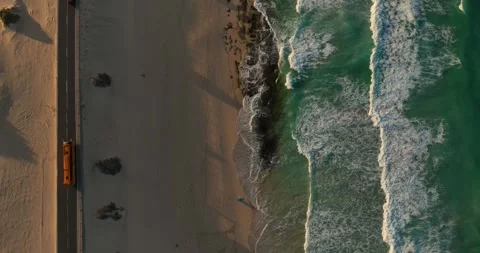Top down drone shot of beach close to a road Stock Footage 343621761
