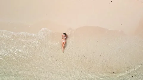 Top Down Drone Shot Of Bikini Woman Relaxing On Bali Beach Shoreline Stock Footage 345018250