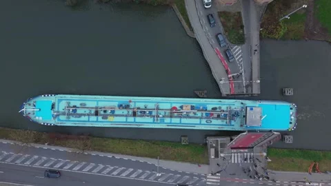 Top-Down Drone Shot of Boat Passing Gentpoort Bridge in Bruges Stock Footage 325531284