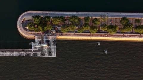 Top-down drone shot captures winding pier and greenery at Parque das Nacoes Video stock 345792467