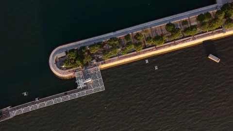 Top-down drone shot captures winding pier and greenery Video stock 345792545