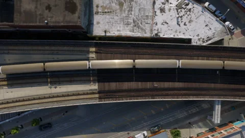 Top-down drone shot of a CTA train crossing a curved elevated track in Chicago Stock Footage 346385163