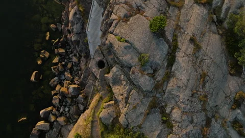 Top down drone shot of a deep rock-carved pothole on the coastline of southern 스톡 동영상 332636479