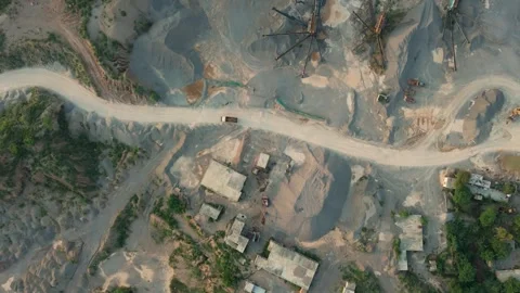 Top down drone shot dump truck driving on a dirt road in stone crushing quarry Stock-Footage 344568597