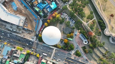 Top-down drone shot flying over hot air balloon above city roads Stock Footage 313465267