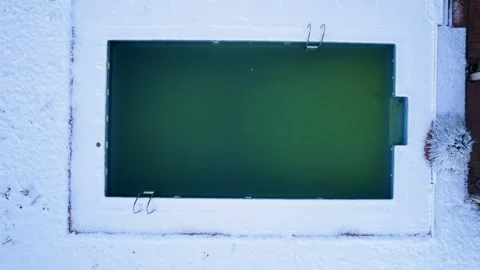 Top down drone shot of frozen pool in snowy backyard The Concept of Cold Video stock 331925444