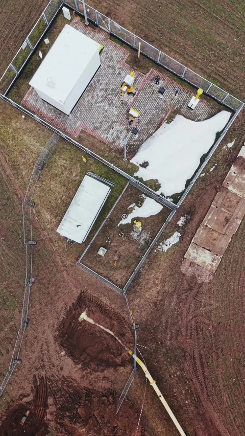Top down drone shot of gas pipeline station in winter field, Poland Stock Footage 334759164