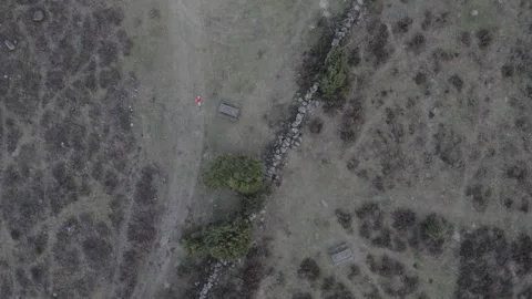 Top down drone shot of hiker in a red jacket 스톡 동영상 321801924