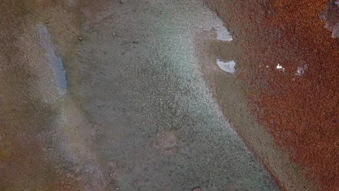 Top-Down Drone Shot Hovering Above Coastline with Shallow Waters, Reflections, R Stock Footage 306310734