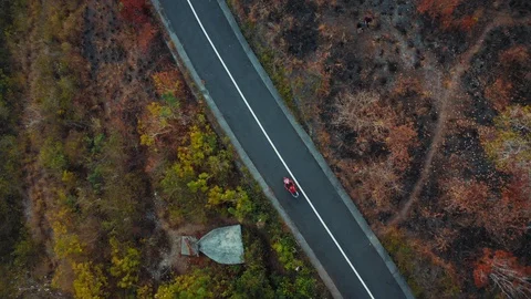 Top Down Drone Shot of Motorcycle Passing Road on Dry Landscape Stock Footage 113824904
