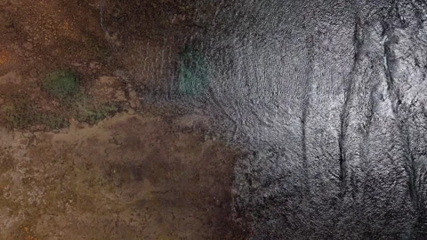 Top-Down Drone Shot Moving Along Coastline with Shallow Waters, Reflections, Roc Stock Footage 306311795