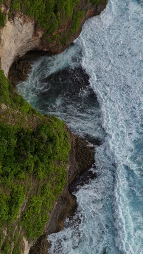 Top Down Drone Shot of Ocean Waves Crashing on Cliffs in Uluwatu, Bali Stock Footage 328719162