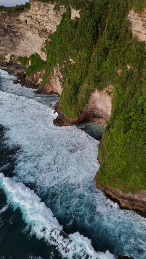 Top Down Drone Shot of Ocean Waves Crashing on Cliffs in Uluwatu, Bali Stock Footage 328719271