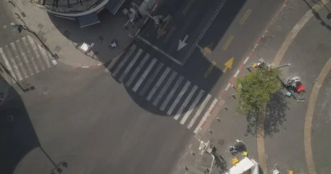 Top down drone shot over city streets, real life footage. woman in white dress Stock Footage 97844282
