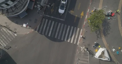 Top down drone shot over city streets, real life footage. woman in white dress Stock Footage 97844619