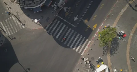Top down drone shot over city streets, real life footage. woman in white dress Stock Footage 97844796