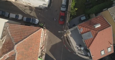 Top down drone shot over city streets, real life footage. woman in white dress Stock Footage 97844978