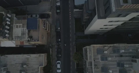 Top down drone shot over city streets, real life footage. woman in white dress Stock Footage 97845503