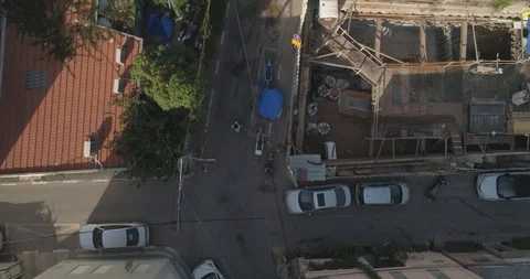 Top down drone shot over city streets, real life footage. woman in white dress Stock Footage 97845575