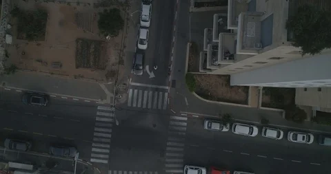 Top down drone shot over city streets, real life footage. woman in white dress Stock Footage 97845883