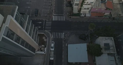 Top down drone shot over city streets, real life footage. woman in white dress Stock Footage 97846100