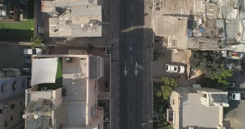 Top down drone shot over city streets, real life footage. woman in white dress Stock Footage 97846251