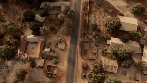 Top-down drone shot over rural village road in Casamance, Senegal Stock Footage 309913724