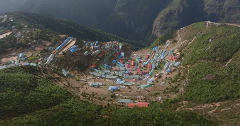 Top-down drone shot over the colorful lodges and cliffs of Namche Bazaar Stockbeeldmateriaal 337394104
