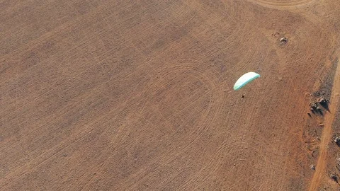 Top down drone shot of powered paragliding flying above the wide Granite Video stock 117129802