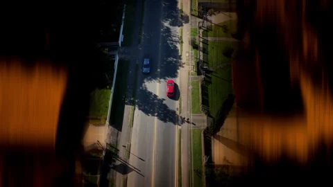 Top Down Drone Shot Red Car Driving Fast Urban Road Motion Blur Vídeos de archivo 331815469