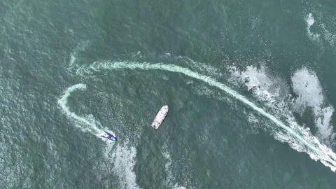 Top down drone shot rising above whale watching boats in cloudy Oregon, USA Stock Footage 317991649