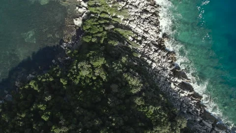 Top down drone shot of rock coast, waves and mediterranean sea, Croatia Video stock 205551209