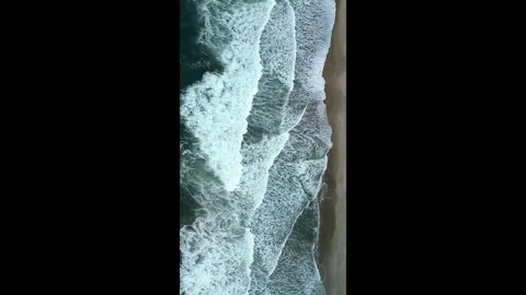 Top Down Drone Shot of Sea Waves and Foam Rolling onto Shoreline Stock Footage 330271063