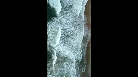 Top Down Drone Shot of Sea Waves and Foam Rolling onto Shoreline Stock Footage 330271071