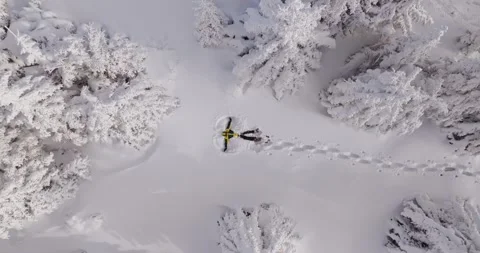 Top down drone shot slowly rotating and descending toward a young man Stock Footage 326529883