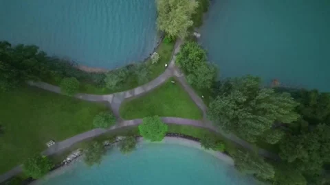 Top down drone shot of small island park surrounded by turquoise water Lunge Stock Footage 322030315