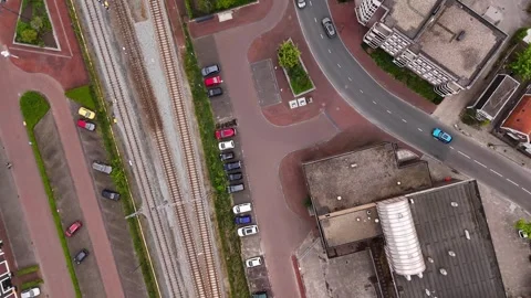 Top-down drone shot of a small town traffic and railway Video stock 335064380